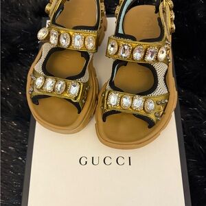 GUCCI
Technical Canvas Calfskin Womens Aguru Trek Crystal Sandals Gold.